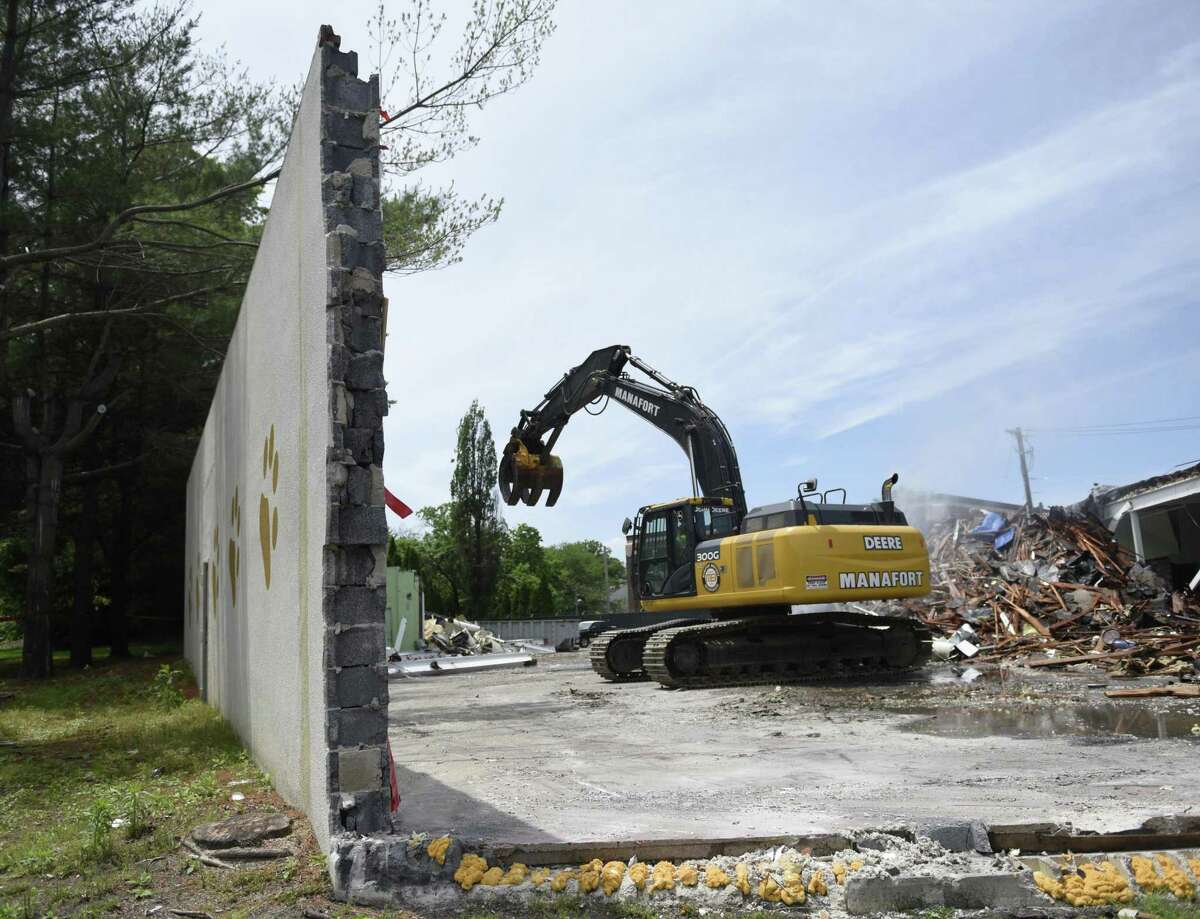 A construction crew begins demolition of the former Pet Pantry building in Greenwich, Conn. Wednesday, June 12, 2019. The Town of Greenwich will begin construction on a new substation and line project at the site that will improve electric reliability wihtin the town.