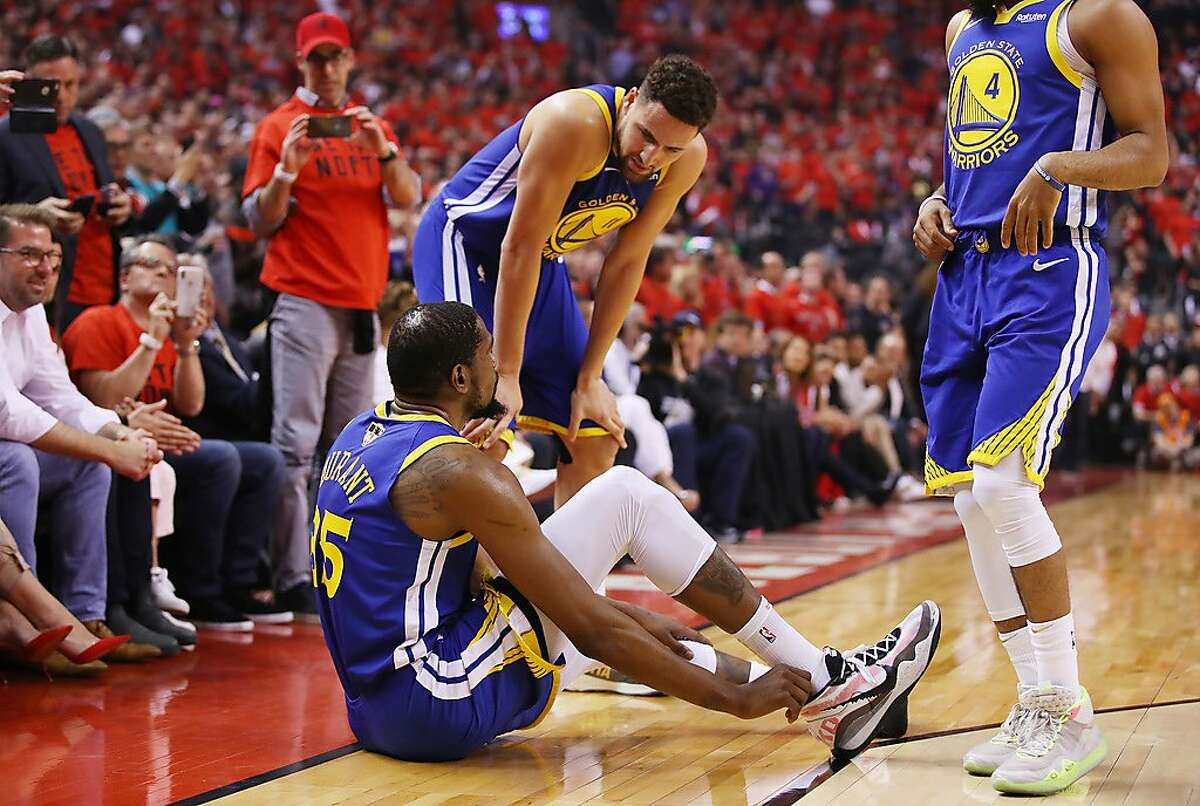 TORONTO, ONTARIO - JUNE 10: Klay Thompson #11 of the Golden State Warriors helps Kevin Durant #35 to his feet in the first half against the Toronto Raptors during Game Five of the 2019 NBA Finals at Scotiabank Arena on June 10, 2019 in Toronto, Canada. NOTE TO USER: User expressly acknowledges and agrees that, by downloading and or using this photograph, User is consenting to the terms and conditions of the Getty Images License Agreement. (Photo by Gregory Shamus/Getty Images)