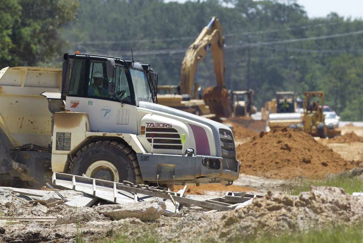 Construction crews work to widen Texas 242 between FM 1314 and I-45 as part of a partnership between Montgomery County and Texas Department of Transportation, Thursday, June 13, 2019.
