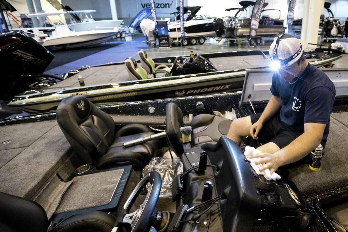 Gatlin Stringer shines up a bass boat while preparing for the opening of the Houston Summer Boat Shows at NRG Center on Tuesday, June 11, 2019, in Houston. The show runs June 12-16.