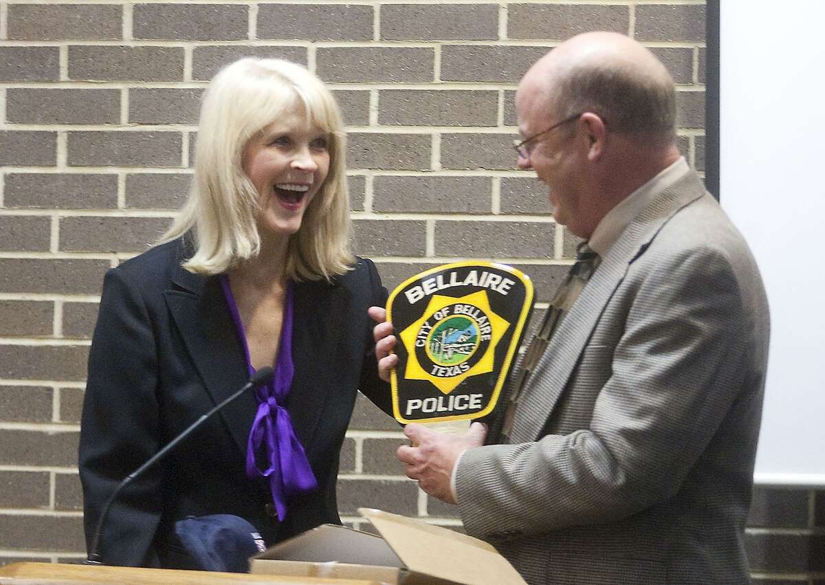 Bellaire's Chief of Police Randall Mack presents outgoing Mayor Cindy Siegel with a plaque during her final city council meeting in July 2017.