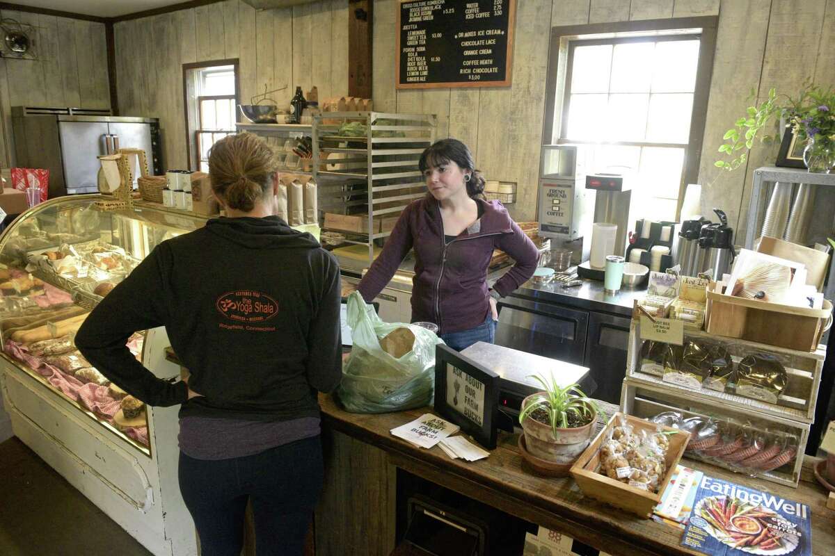 Kristen Apellaniz, right, helps Susan Runge, of Redding at Holbrook Farm in Bethel. Friday, June 14, 2019, in Bethel, Conn. The owners of Taproot restaurant in Bethel and Redding Roadhouse are leasing the farm.