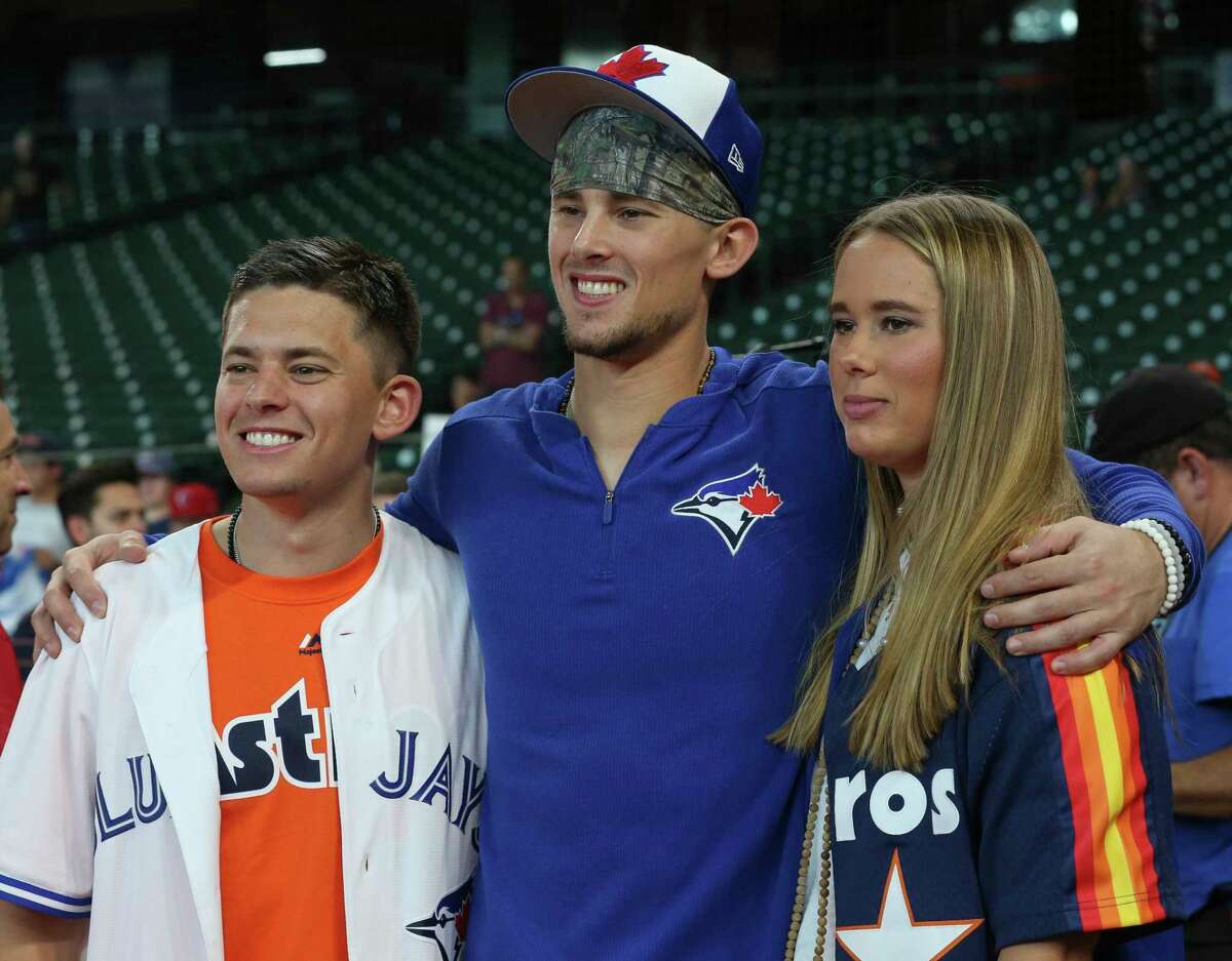 Toronto Blue Jays rookie second baseman Cavan Biggio, center, takes a photograph with his brother, Conor, and sister, Quinn, during practice before the MLB game against the Houston Astros at Minute Maid Park on Friday, June 14, 2019, in Houston. Biggio is the second son of former Houston Astros player and National Baseball Hall of Famer Craig Biggio. He was facing the Astros for the first time on Friday since he was called up to the major league lsat month.
