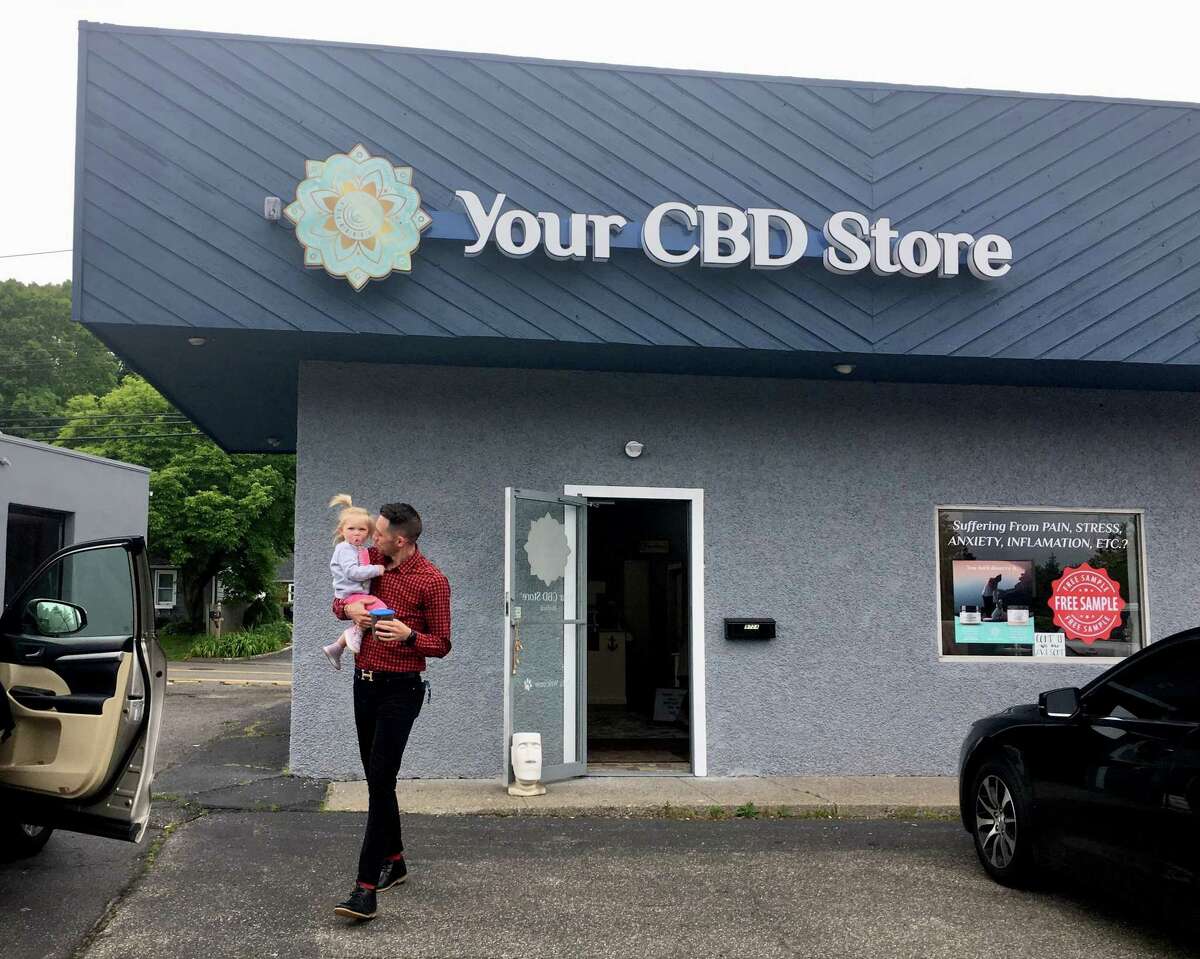 Clayton Percy, co-owner and general manager of the Your CBD Store location in Milford, in the store with products. The store is one of nearly 400 franchised or affiliated with the Florida company Sunflora.