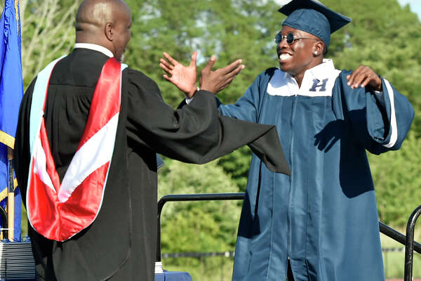New Haven, Connecticut - Friday, June 14, 2019: Zahyid Jackson gets a warm welcome from Principal Glen Worthy before getting his diploma during the Hillhouse H.S. 160th Commencement Exercises for the Class of 2019 Friday at Bowen Field in New Haven.