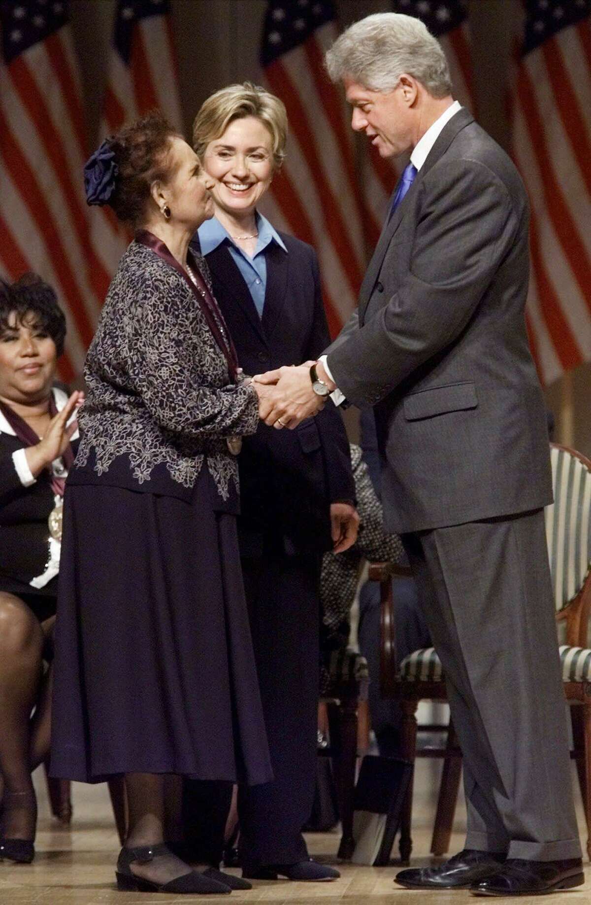 President Clinton talks with Mexican singer Lydia Mendoza after presenting her with a National Medal of Arts, Wednesday Sept. 29, 1999 in Washington. First lady Hillary Rodham Clinton is at center. (AP Photo/Khue Bui)