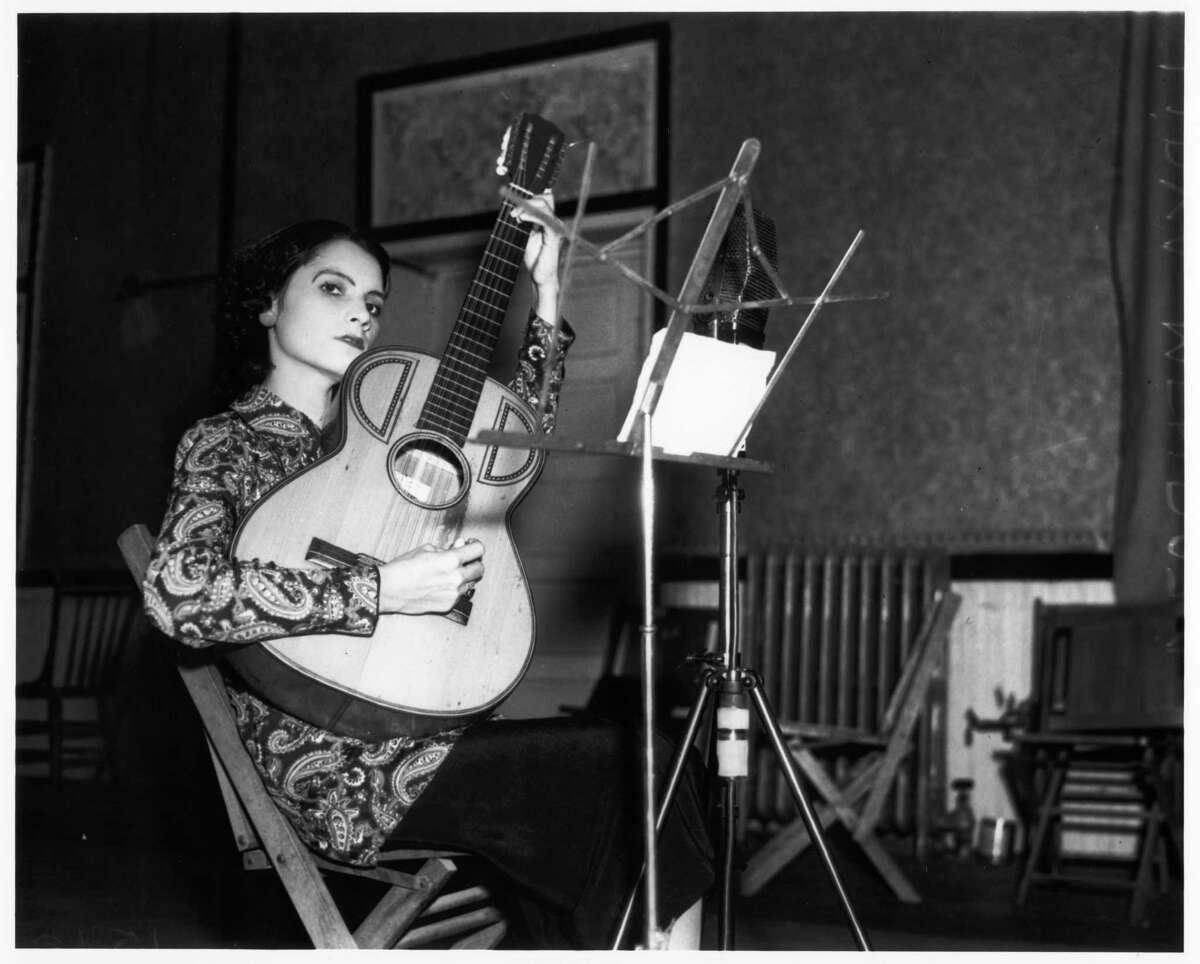 Lydia Mendoza, 20, records for RCA-Victor in San Antonio on Oct. 21, 1936. Mendoza rarely smiled, even for publicity photos.