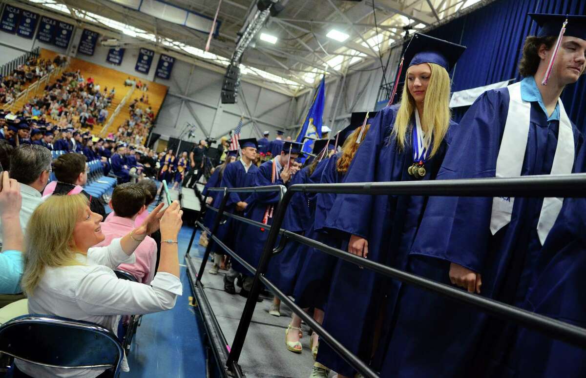 Graduate Nicole Berry pauses as her mom Kathy snaps her picture during New Fairfield's High School's 44th Commencement Exercises at at the O'Neill Center at Western Connecticut State University in Danbury, Conn., on Saturday June 15, 2019.
