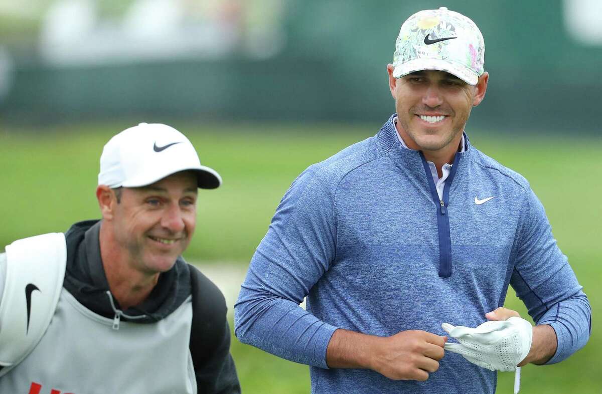 PEBBLE BEACH, CALIFORNIA - JUNE 13: Brooks Koepka of the United States (R) and caddie, Richard Elliott, laugh on the 18th hole during the first round of the 2019 U.S. Open at Pebble Beach Golf Links on June 13, 2019 in Pebble Beach, California. (Photo by Warren Little/Getty Images)