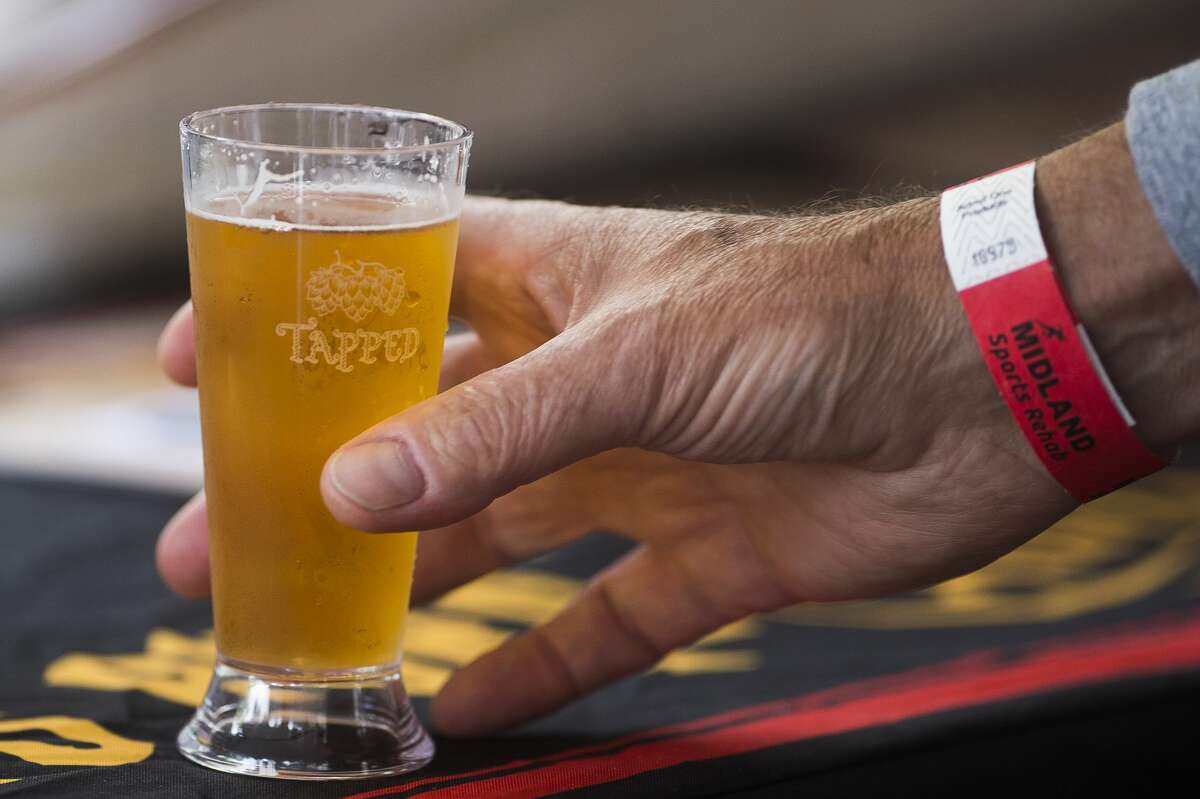 Hundreds of people sample craft beers during the Tapped beer festival on Saturday, June 15, 2019 in downtown Midland. (Katy Kildee/kkildee@mdn.net)
