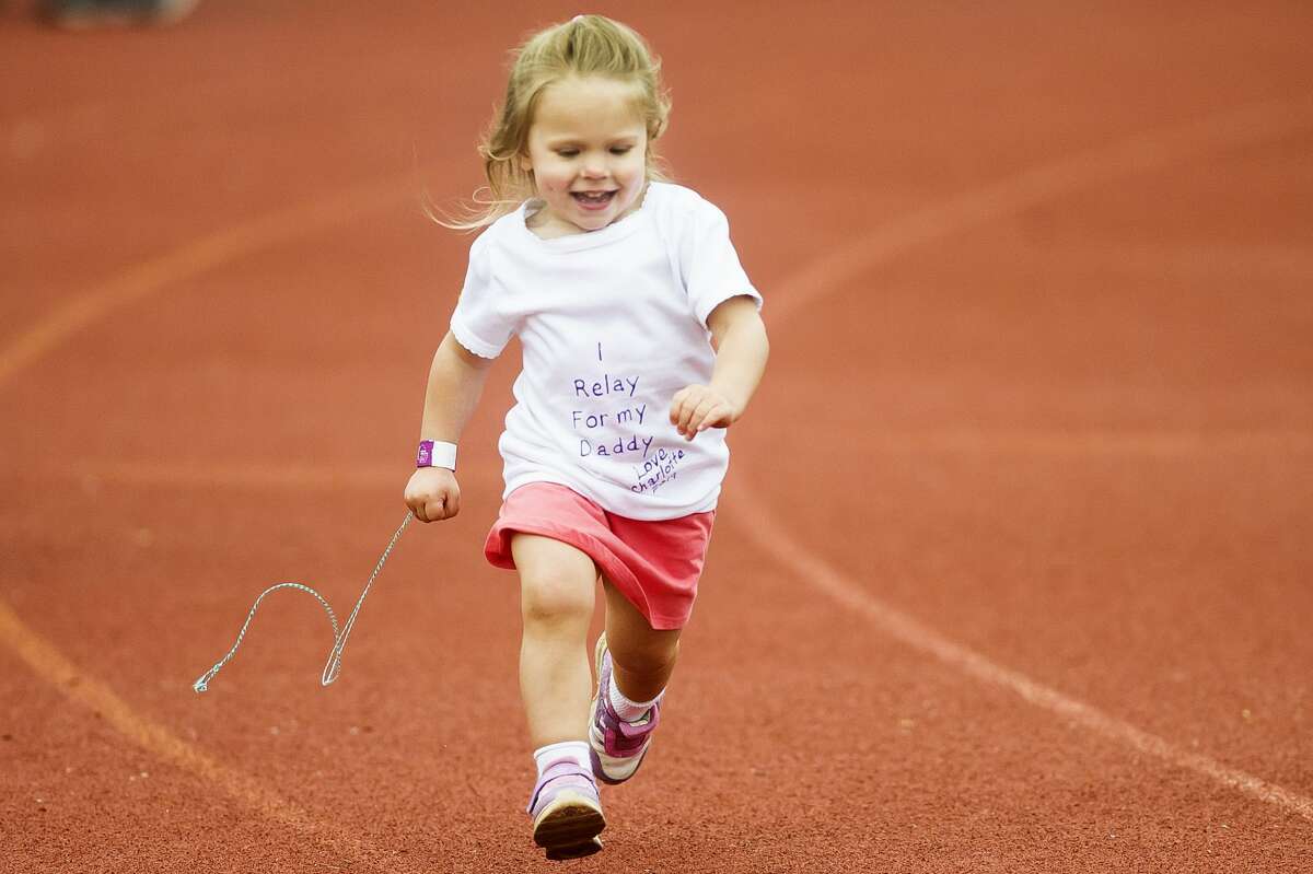 Charlotte Begley of Coleman, 3, runs around the track during the Relay for Life of Midland County on Saturday, June 15, 2019 at Midland Community Stadium. (Katy Kildee/kkildee@mdn.net)