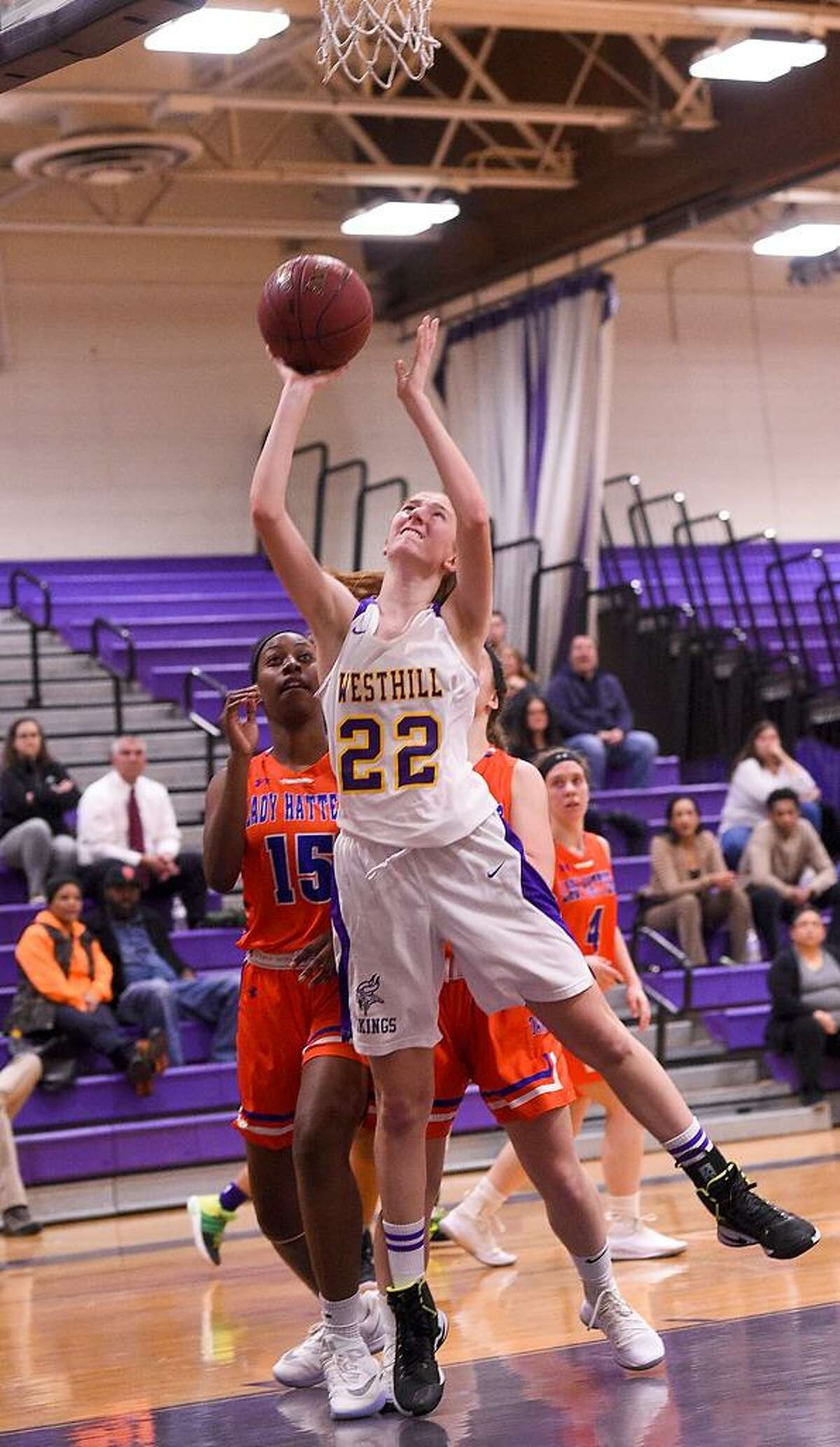 Westhill’s Grace Hansen (22) shoots against Danbury’s Tanisha Cunningham (15) during an FCIAC girls basketball game at Westhill High School in Stamford on Jan. 11, 2018. Hansen will forego basketball and soccer, but will play lacrosse at UMass-Lowell in the fall.
