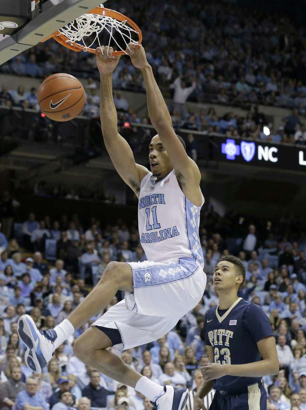 FILE - In this Feb. 14, 2016, file photo, North Carolina's Brice Johnson (11) dunks as Pittsburgh's Cameron Johnson (23) watches during an NCAA college basketball game in Chapel Hill, N.C. Johnson leads the ACC with 18 double-doubles. (AP Photo/Gerry Broome, File)