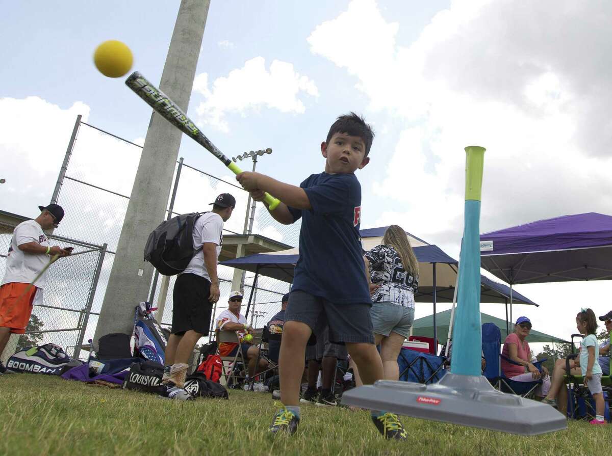Weston Carbajal, 4, hits off a tee before the kids for cops game, as part of the inaugural Americans Stand United First Responder Softball Tournament at Carl Barton, Jr. Park, Saturday, June 15, 2019, in Conroe. Each child was pair with a firefighter or police officer as a coach for the game. The inaugural tournament brought together community members with 150 first responders from Montgomery and Harris County.