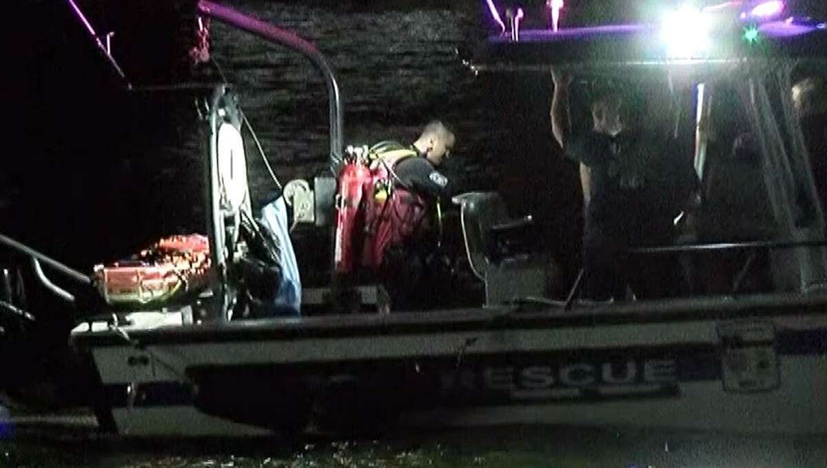 A search and rescovery diver prepares to jump in the waters of Lake Conroe to try and find the body of a Tomball man who drowned Saturday evening.