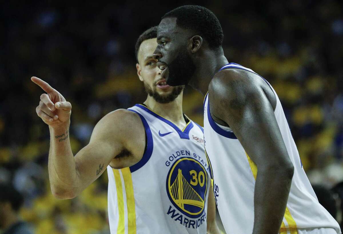 Golden State Warriors Stephen Curry and Draymond Green talk in the fourth quarter during game 1 of the Western Conference Semifinals between the Golden State Warriors and the Houston Rockets at Oracle Arena on Sunday, April 28, 2019 in Oakland, Calif.