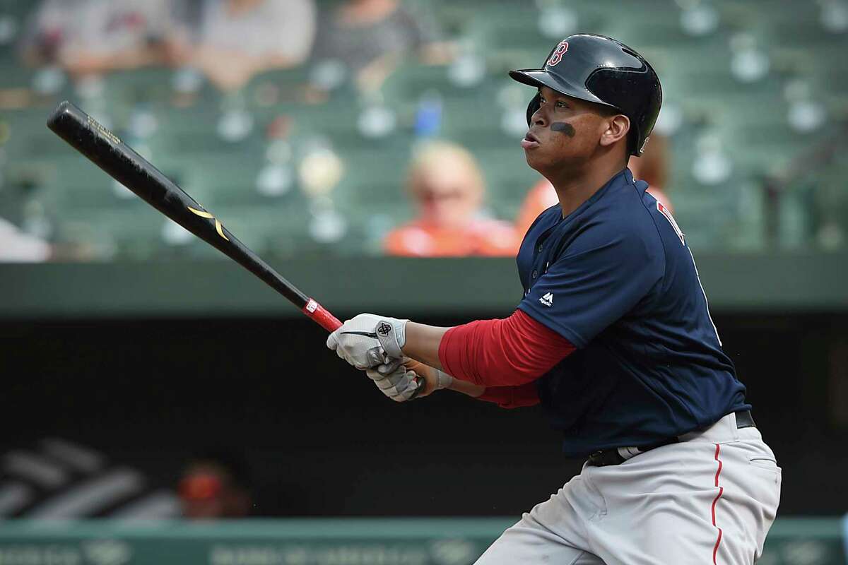 Boston Red Sox's Rafael Devers follows through on a solo home run against the Baltimore Orioles in the 10th inning of a baseball game Sunday, June 16, 2019, in Baltimore. (AP Photo/Gail Burton)