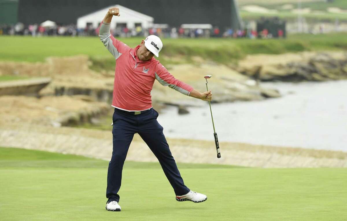 Gary Woodland begins his celebration after sinking a birdie putt on No. 18 to complete his championship run in the U.S. Open at Pebble Beach.