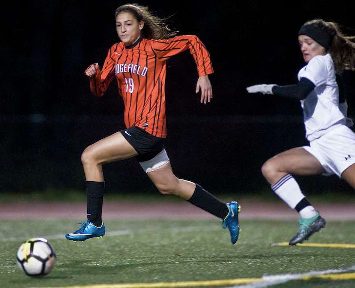 Carrina Dabroi beats a Trumbull player to the ball during Thursday night's FCIAC quarterfinal game. - Scott Mullin photo