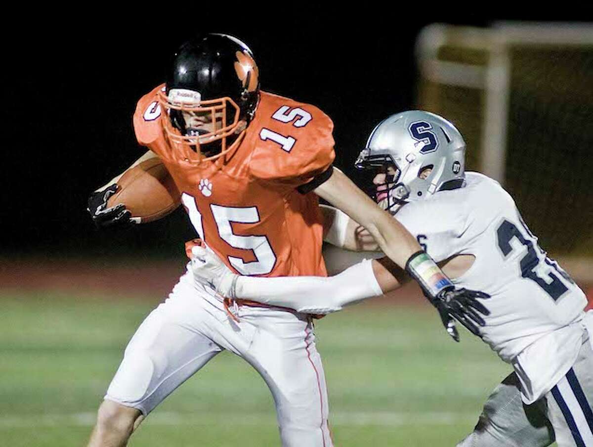 Gianni Gorham looks to elude a Staples player after catching a pass in Friday night's game. - Scott Mullin photo