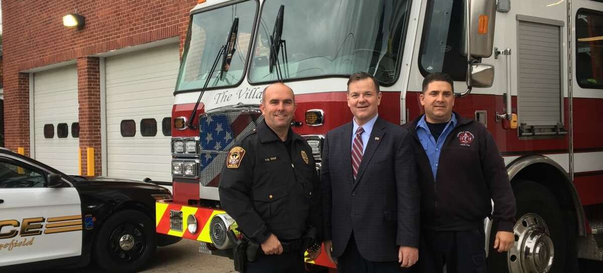 Ridgefield Police Officer Chris Daly, president of the Ridgefield Police Union, State Rep. John Frey and Ridgefield Fire Department Lt. Tony Cerulli in front of the Ridgefield Fire Department on Catoonah Street.
