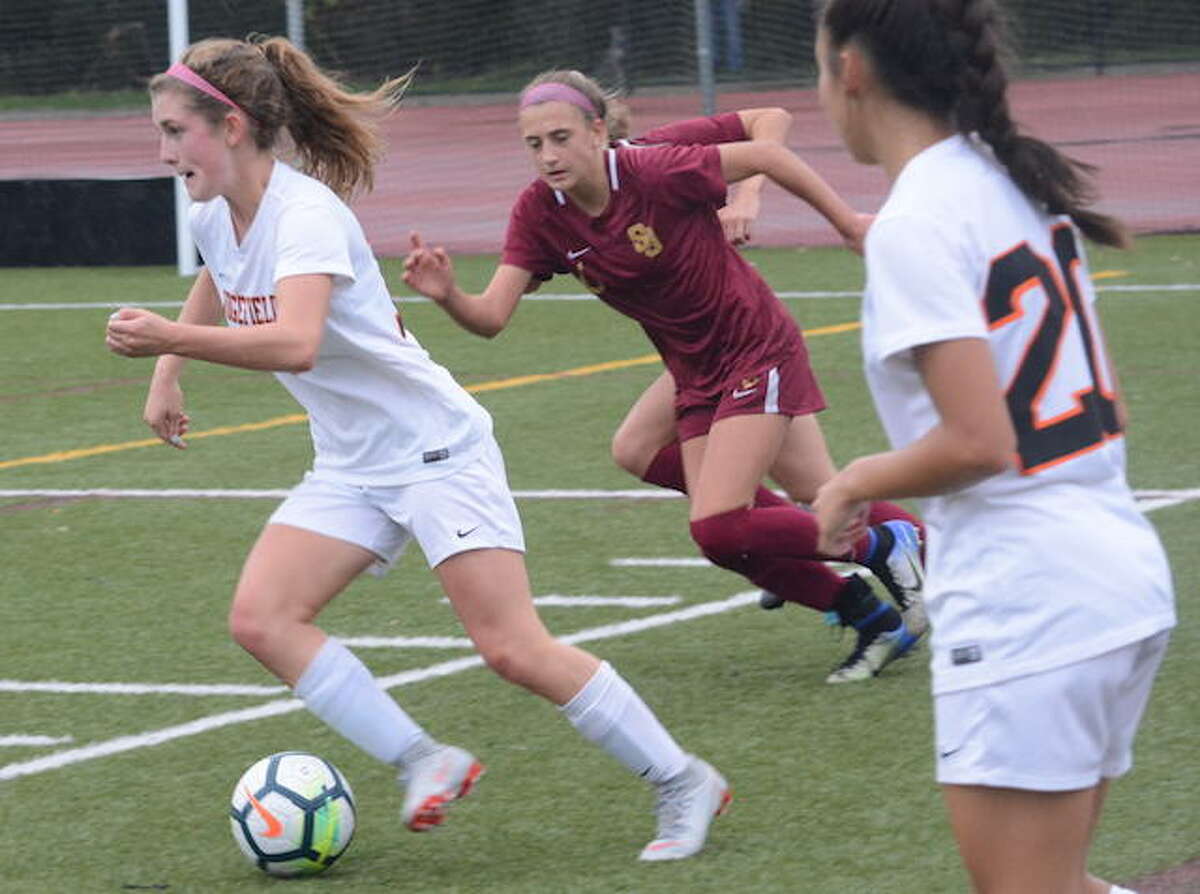 Caitlin Slaminko dribbles past a St. Joseph player during Monday's game in Trumbull. - Andy Hutchison photo