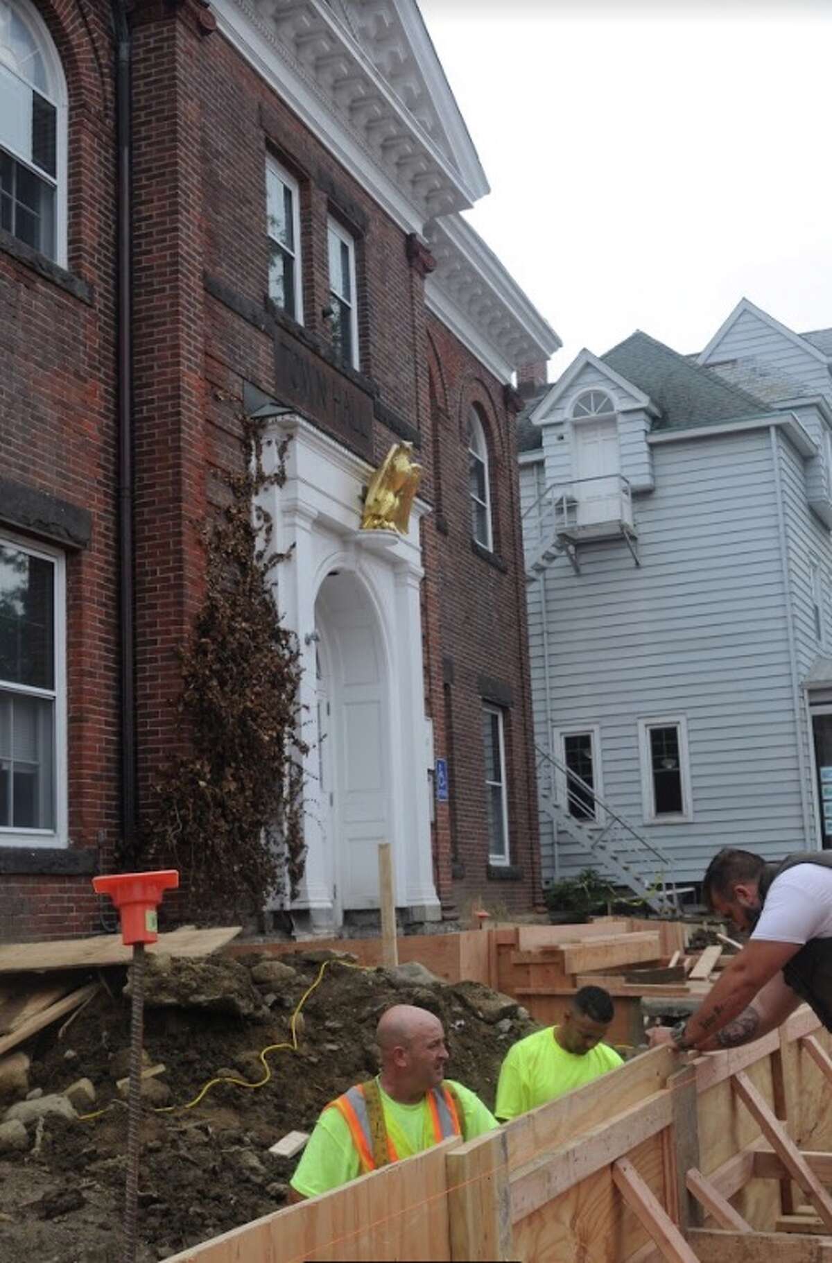 Construction work on the front of town hall is likely to go another month. People can enter off Bailey Avenue. — Macklin Reid photo