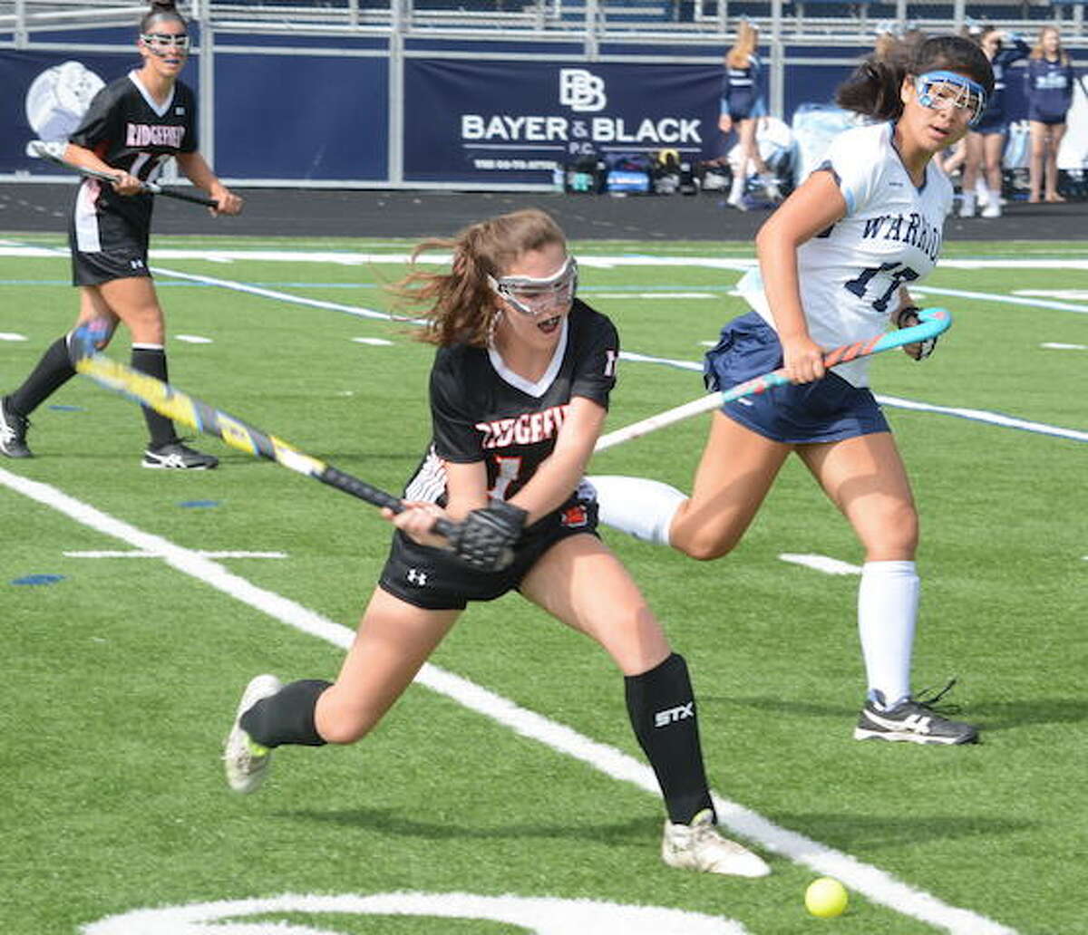 Ridgefield's Jen Paul clears the ball during a field hockey game earlier this season. The Tigers fell to New Canaan, 2-0, on Monday. — Andy Hutchison photo