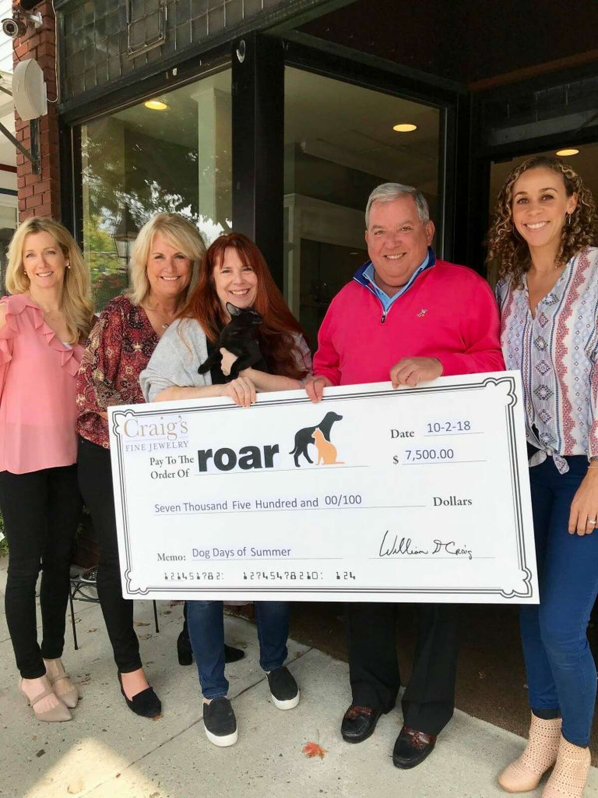 Pictured, from left to right: Deb Larson and Jen Whipple of Craig's Fine Jewelry; Kerry Dobson of ROAR and Audrey who is available for adoption; and Bill Craig and Laura Verses of Craig's Fine Jewelry.