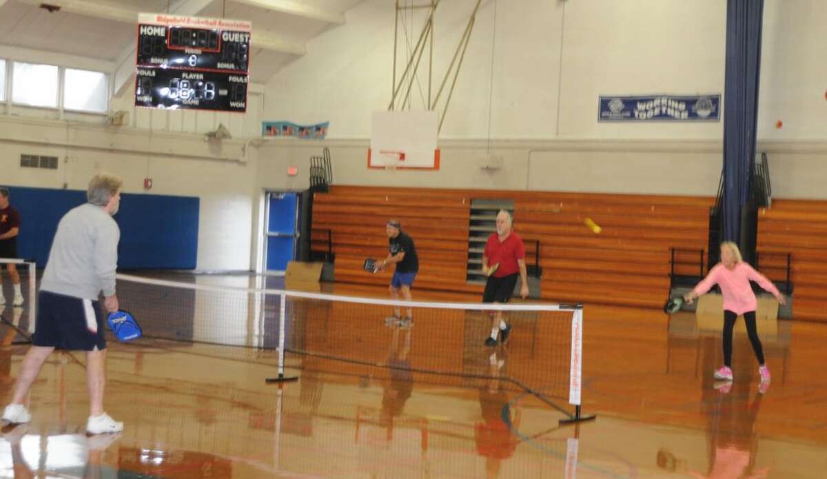 Pickleball players' game is similar to tennis with a lower net, smaller court, and different paddle and balls. These players were on the court Monday, Dec. 17, in Yanity gym. - Macklin Reid photo