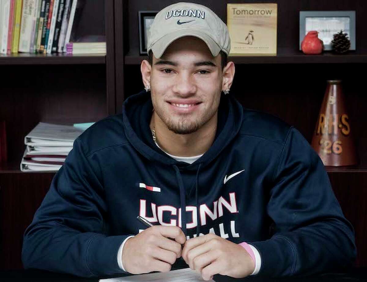 Jackson Mitchell signed a national letter of intent to play football at the University of Connecticut on Wednesday morning at Ridgefield High School. — Scott Mullin photo