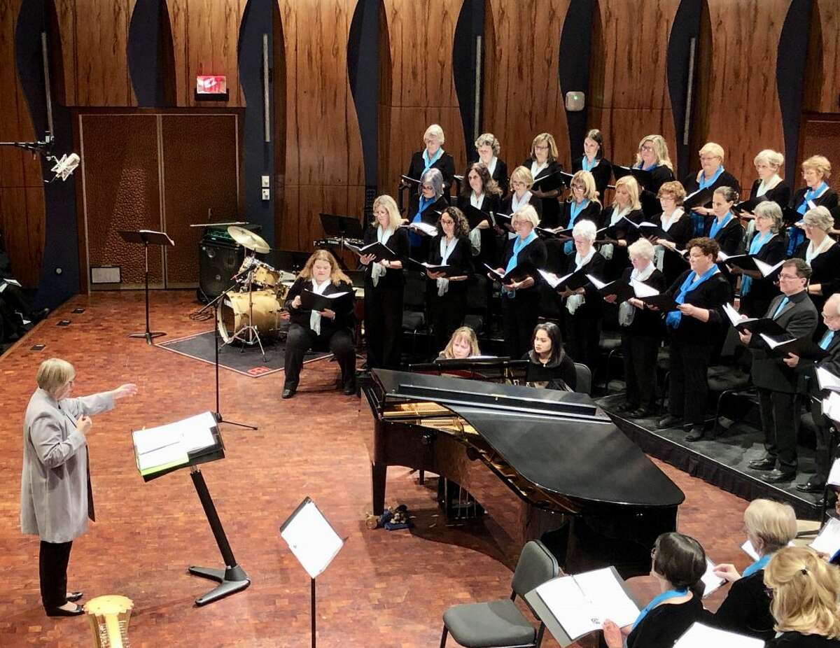 Daniela Sikora conducts the world premiere of “The Gift to Sing,” a piece written by composer Thomas LaVoy, in November.