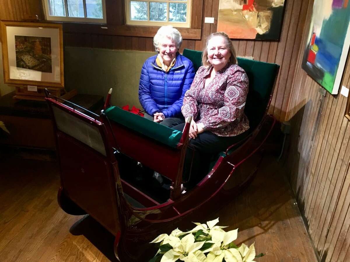 Sylvia Pinchbeck Sturges, left, with Hilary Micalizzi, board president, Keeler Tavern Museum and History Center, seated in the antique sleigh that she recently donated.