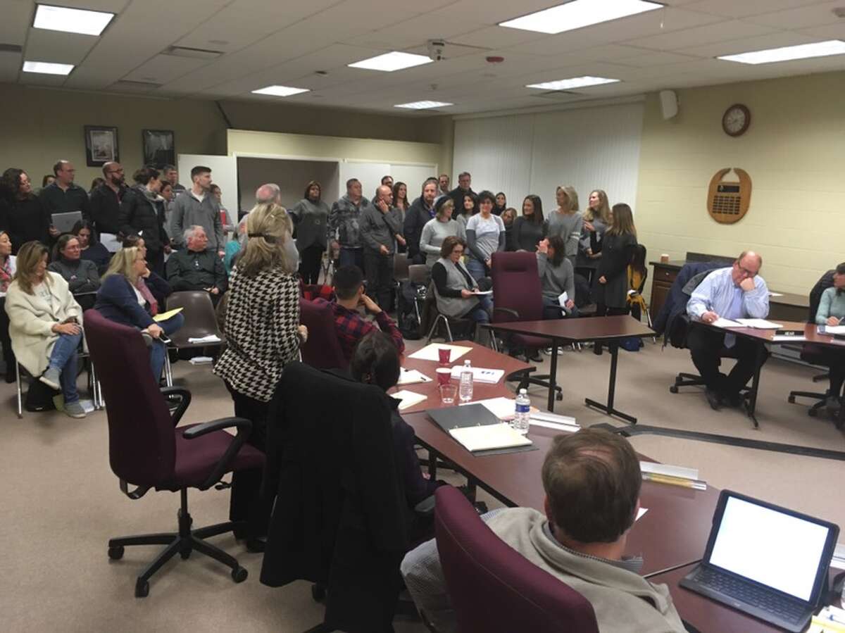 Forty six residents stood up at Monday night's Board of Education meeting to demonstrate that they were against the initiative to start Ridgefield schools later. - Peter Yankowski photo