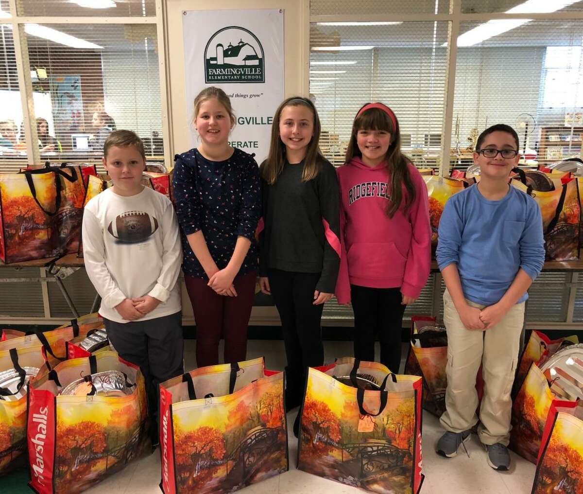 The Farmingville Elementary School community collected and delivered 28 Thanksgiving baskets to the Women's Center of Greater Danbury. Each basket contained a full Thanksgiving feast, including a gift card to purchase a turkey. Since the program started, Farmingville has donated over 150 meals to the Women's Center. Pictured from left to right: Brady Grijns, Lotte Groot, Kylie Lassow, Brenna Williams and Shesh Sheridan.