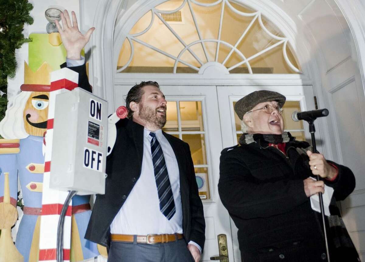 Mike Flynn,Executive Director of the Boys & Girls Club throws the switch and celebrates the lights with Ira Joe Fisher who was the emcee. - Scott Mullin photo
