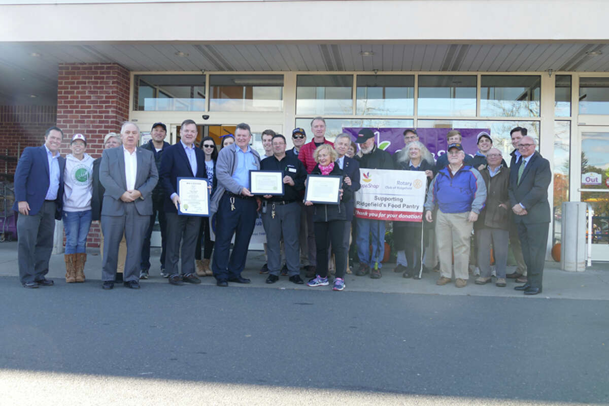 First Selectman Rudy Marconi and state Rep. John Frey gave the Rotary Club of Ridgefield a special recognition in front of Stop and Shop on Oct. 25 for racking up an estimated $500,000 in donated groceries from its monthly food drives. — Peter Yankowski photo