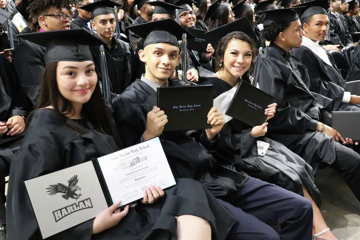 First graduates of Harlan High School cross the stage