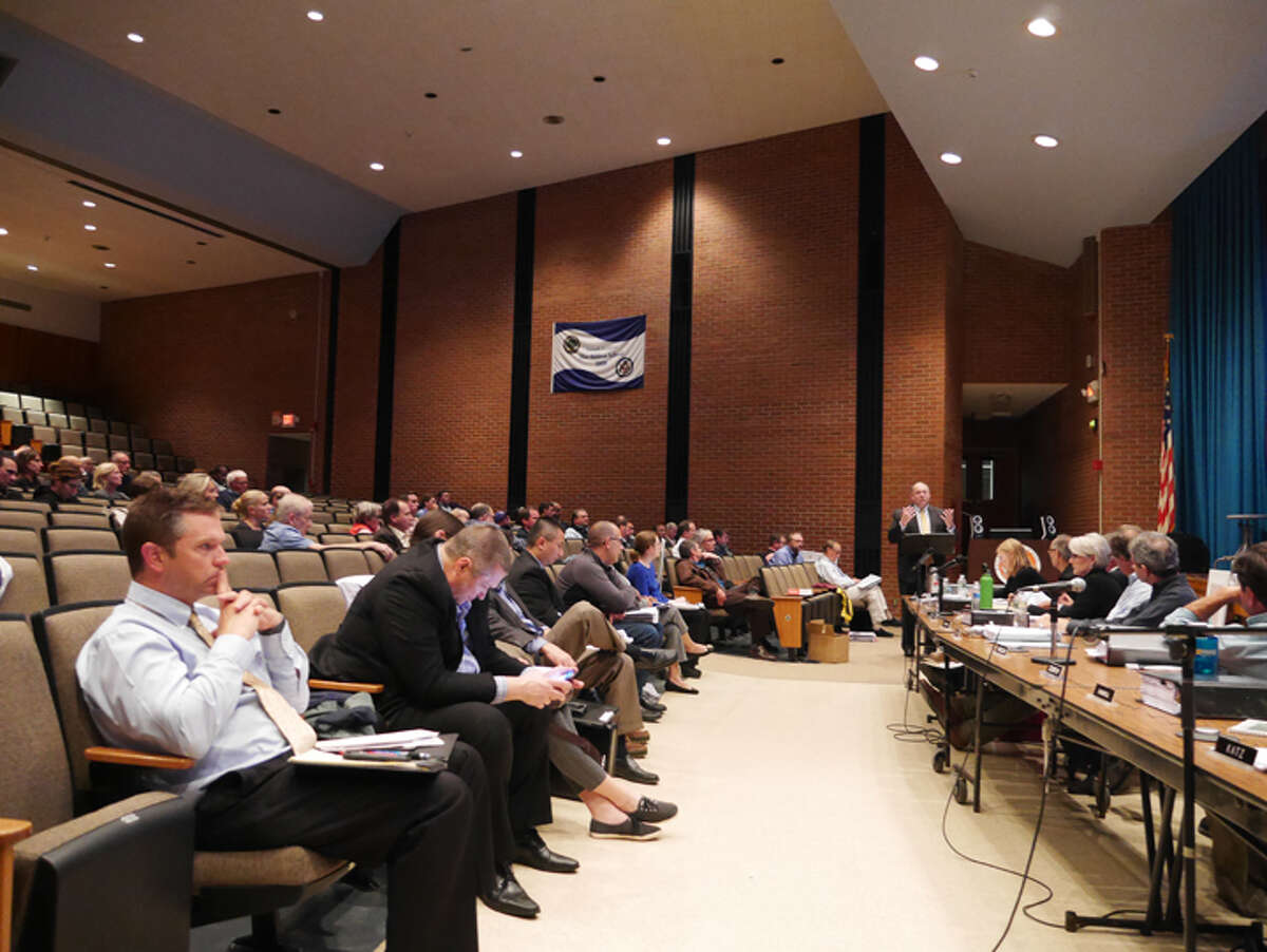 Attorney Peter Olson addresses the Planning and Zoning Commission during the second public hearing for a proposed private skating club at 340 Peaceable Street on Tuesday, Sept. 25. The meeting drew around 100 residents to the auditorium of East Ridge Middle School, and concluded before any residents were able to speak. - Peter Yankowski photo