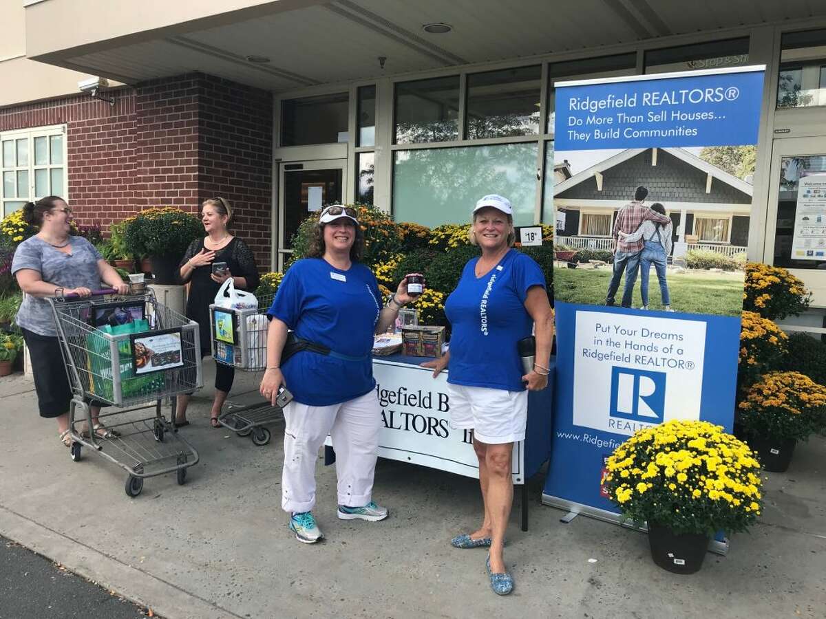 Colette Kabasakalian, director of community outreach for the Ridgefield Board of Realtors (RBOR), collects donated food with Mary Pat Sexton, the 2018 RBOR president.