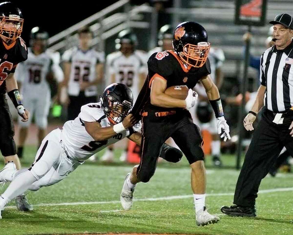Jack Englert takes a Stamford defender along for the ride during a run Friday night. — Scott Mullin photo