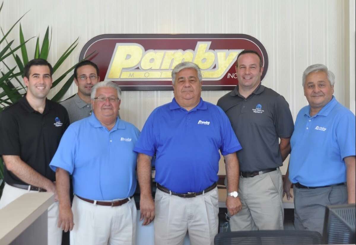 At the front desk of Pamby Motors showroom are six Pambianchi men representing two generations: From left, Nick, Andy, John, Mike, Tim and Fred. —Macklin Reid photo