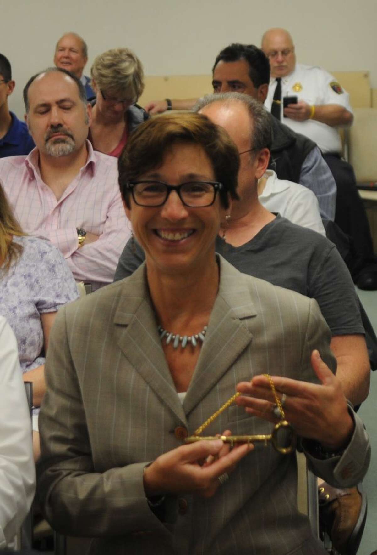 Wendy Lionetti, new town clerk, displays the ceremonial “key to the office” presented to her Monday night by retiring Town Clerk Barbara Serfilippi. — Macklin Reid photo