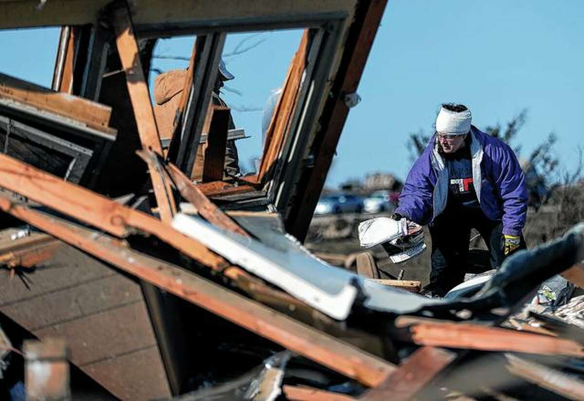 Candy Trudell searches for her belongings in the rubble after a tornado struck the town of Rochelle in Illinois in April 2015.