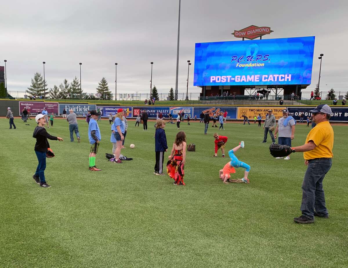 Fathers play catch on the field at Dow Diamond on Father's Day, June 16, 2019. (Photo provided/Ashley VanOchten, Great Lakes Loons)