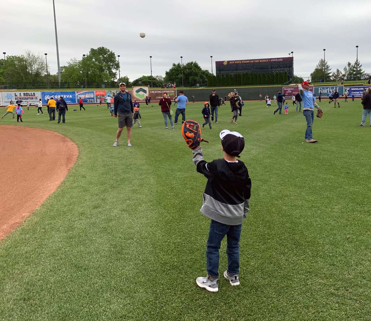 Fathers play catch on the field at Dow Diamond on Father's Day, June 16, 2019. (Photo provided/Ashley VanOchten, Great Lakes Loons)