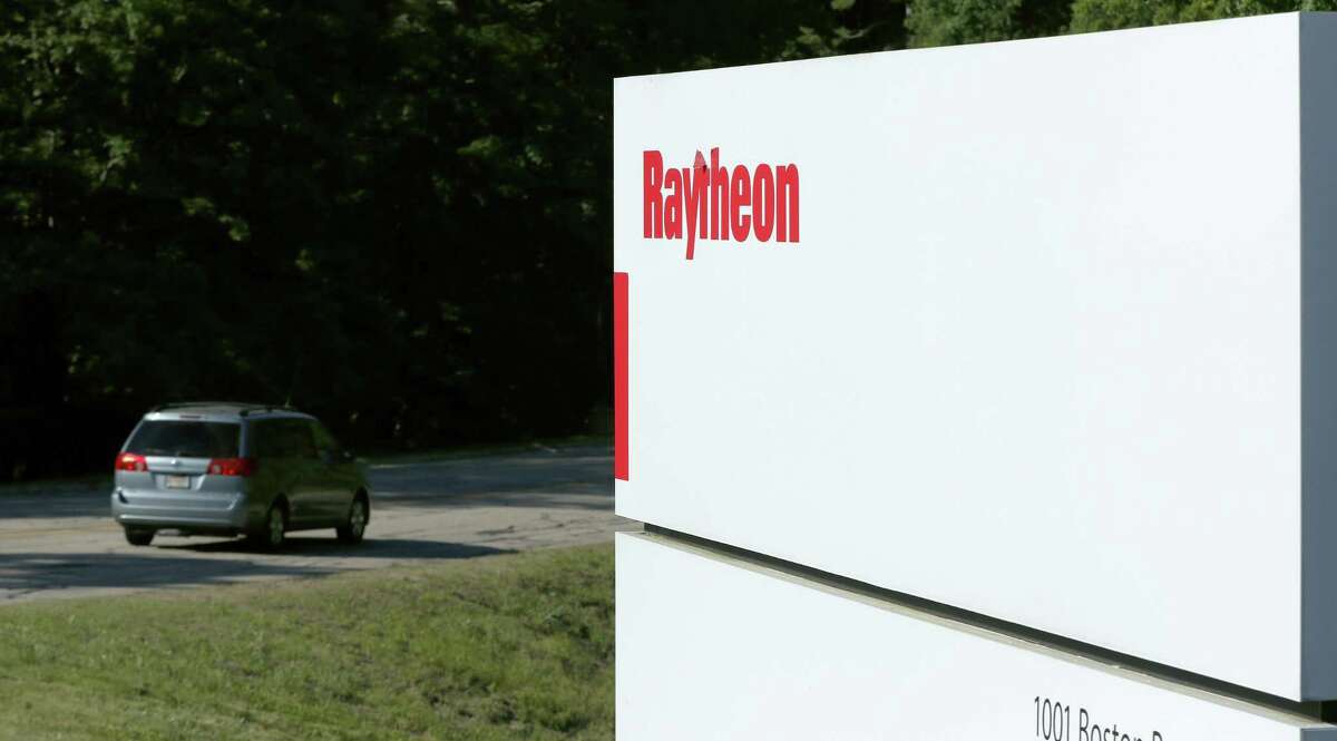 Workers drive into the Raytheon facility Monday, June 10, 2019, in Marlborough. Raytheon Co. and United Technologies Corp. are merging in a deal that creates one of the world's largest defense companies. (AP Photo/Bill Sikes)