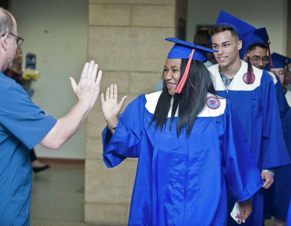 Alternative School for Excellence (ACE) graduate Artazia Taft is congratulated at the graduation ceremony at WestConn’s Midtown Student Center. Monday, June 17, 2019
