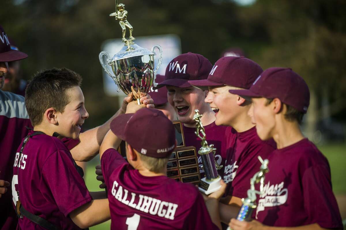 Wilson Miller players receive a trophy after their Little League major city championship victory over Kutchey Landscaping on Monday, June 17, 2019 at Northeast Little League in Midland. (Katy Kildee/kkildee@mdn.net)