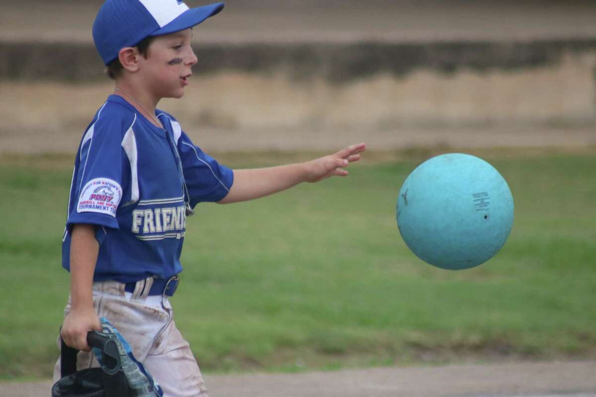 Ryder Goebel relaxes after Sunday afternoon's championship game by bouncing a ball far larger than a baseball down Renwick Park's sidewalk. Ryder was a tough competitor for the summer's first all-star tournament.